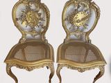 pair of antique french style chairs with gold leaf and floral designs