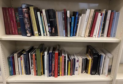 a book shelf with many books on it in a room