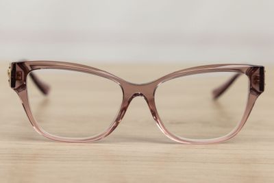 the glasses are made of plastic and have a brown frame