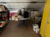 a room filled with boxes and a table in it