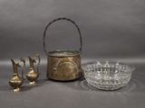 three pieces of silver and glass on a gray surface