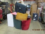 a pile of furniture in a warehouse with boxes and other items