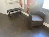 a wicker chair and a small table in a room