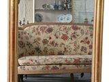 a couch and a mirror in a room