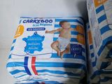 two packs of baby diapers sitting next to each other on a table