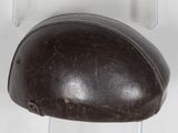a brown helmet hanging on a white wall