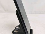 a close up of a cell phone on a stand on a table