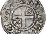 une vieille pièce d'argent ornée d'une croix