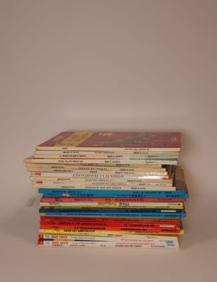 several children ' s books stacked on top of each other on a table