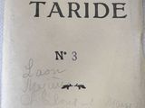 an old book with writing on it sitting on a table