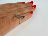a woman ' s hand with red nails and a ring on it