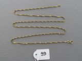 a close up of a gold chain with a price tag on it