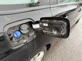 a black car that has a blue button on the side of it