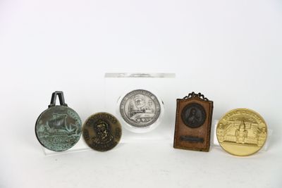 several different types of coins are displayed on a white surface