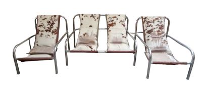 three metal chairs with cow hide covers on them sitting next to each other