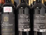 many bottles of wine sitting on a shelf in a store