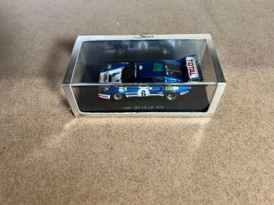 a toy truck in a clear box on the floor