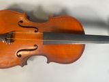 an old violin sitting on top of a table next to a wall