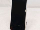 a cell phone that is sitting on a stand on a table