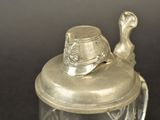 a glass jar with a silver lid on a table