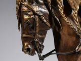 bronze statue of a horse with braids on its head