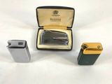 two lighters and a lighter case sitting on a table