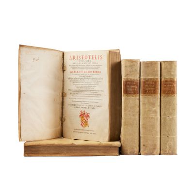three old books sitting on top of a wooden shelf next to each other