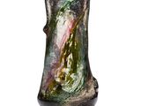 a glass vase that is sitting on a white surface