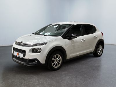 Une Citroën blanche est garée dans une pièce blanche