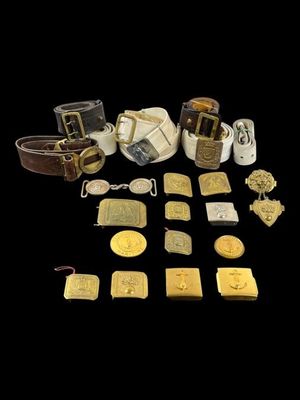 some gold and silver items are arranged on a black surface