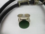a bracelet and a ring on a table with a coin
