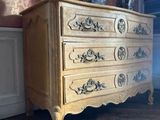a dresser with a vase on top of it in a room