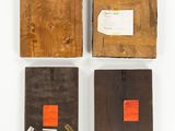 four pieces of wood with orange tags on them on a white surface