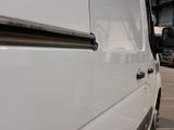 a white van that is parked in a parking lot