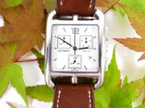 a watch that is sitting on top of a leaf
