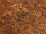 a close up of a wooden floor with a flower design