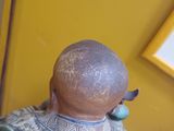 a statue of a man with a bald head on a table
