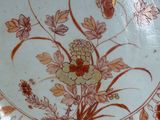 a plate with a floral design on it on a table