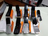 a lot of cell phones that are sitting on a table