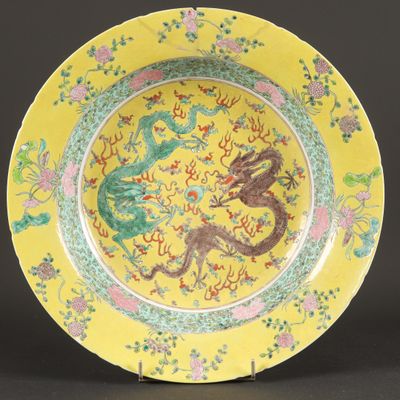 an image of a yellow plate with a dragon and flowers on it
