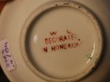 someone is holding a white plate with a red writing on it