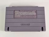 an old nintendo game console sitting on top of a white table