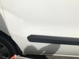 a white car that has a broken door handle on the side of it