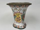 a vase with a floral design on it on a white surface