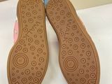 the shoes are brown and have a pink design on them