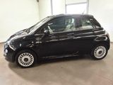 the small black car is parked in a large room