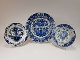 trois assiettes bleues et blanches ornées de fleurs, posées sur une table