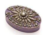 an image of a purple and gold box with pearls on it
