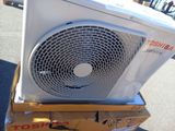 a white air conditioner sitting on top of a cardboard box
