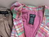 a pile of clothes sitting on top of a table next to a wall